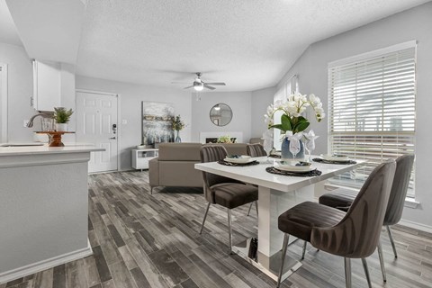 an open living room and dining room with a table and chairs